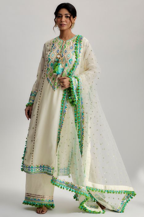A model showcasing Nishika Long Kurta With Palazzo In Ivory by Gopi Vaid from Gopi Vaid's collection