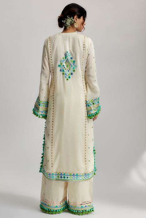 A model showcasing Nishika Long Kurta With Palazzo In Ivory by Gopi Vaid from Gopi Vaid's collection