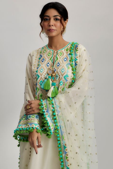 A model showcasing Nishika Long Kurta With Palazzo In Ivory by Gopi Vaid from Gopi Vaid's collection