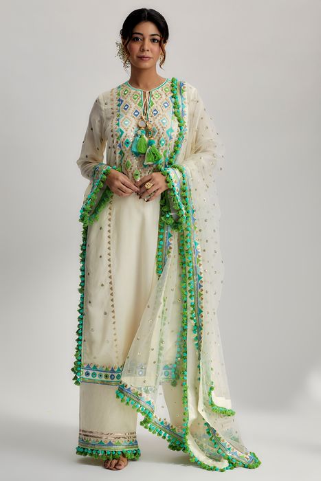 A model showcasing Nishika Long Kurta With Palazzo In Ivory by Gopi Vaid from Gopi Vaid's collection