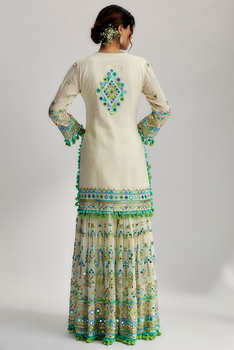 A model showcasing Ivory Friya Short Kurta Sharara Set by Gopi Vaid from Gopi Vaid's collection