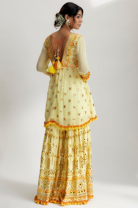 A model showcasing Yellow Sophie Peplum With Sharara Set by Gopi Vaid from Gopi Vaid's collection