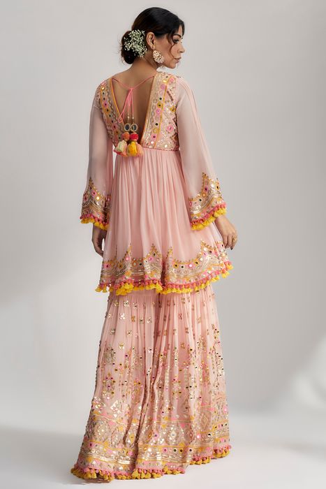 A model showcasing Pink Zohra Peplum With Sharara by Gopi Vaid from Gopi Vaid's collection
