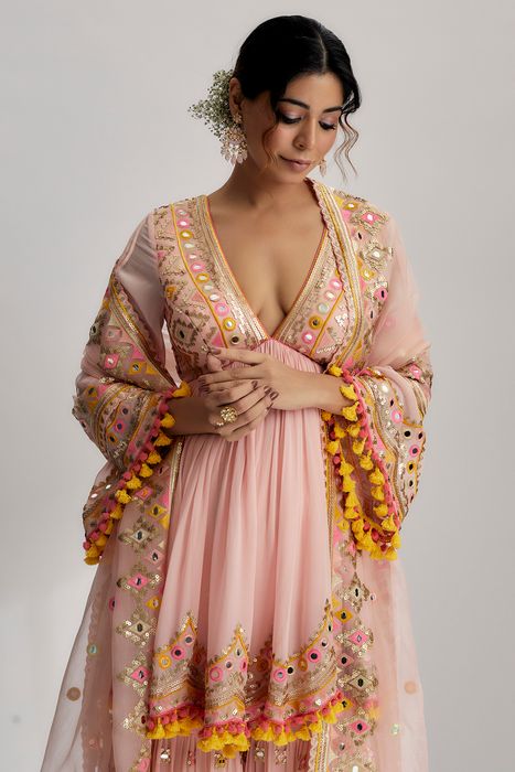 A model showcasing Pink Zohra Peplum With Sharara by Gopi Vaid from Gopi Vaid's collection
