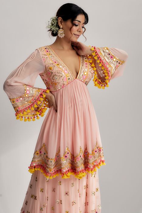 A model showcasing Pink Zohra Peplum With Sharara by Gopi Vaid from Gopi Vaid's collection