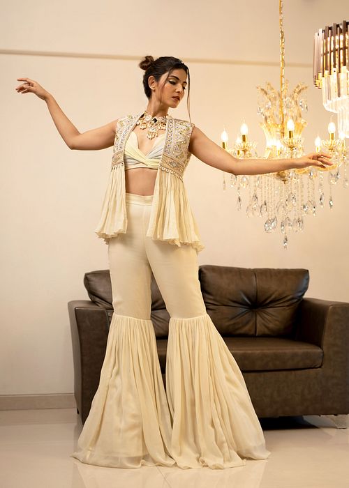 A model showcasing Cream Gharara Jacket Set by Foram Patel from Foram Patel's collection