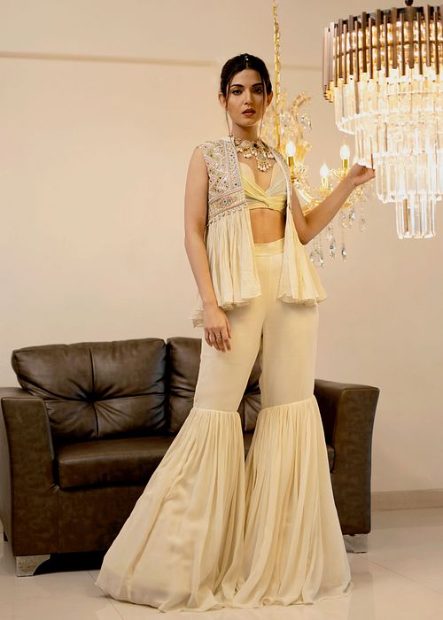 A model showcasing Cream Gharara Jacket Set by Foram Patel from Foram Patel's collection
