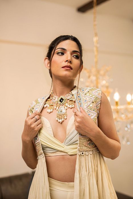 A model showcasing Cream Gharara Jacket Set by Foram Patel from Foram Patel's collection