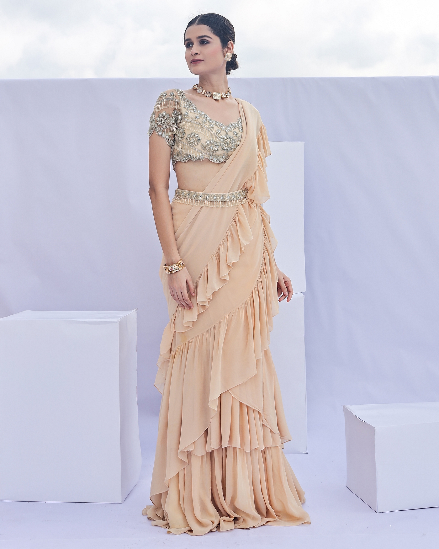A model showcasing Gold Embroidered Predraped Ruffle Saree Set Feature image by Foram Patel from Foram Patel's collection