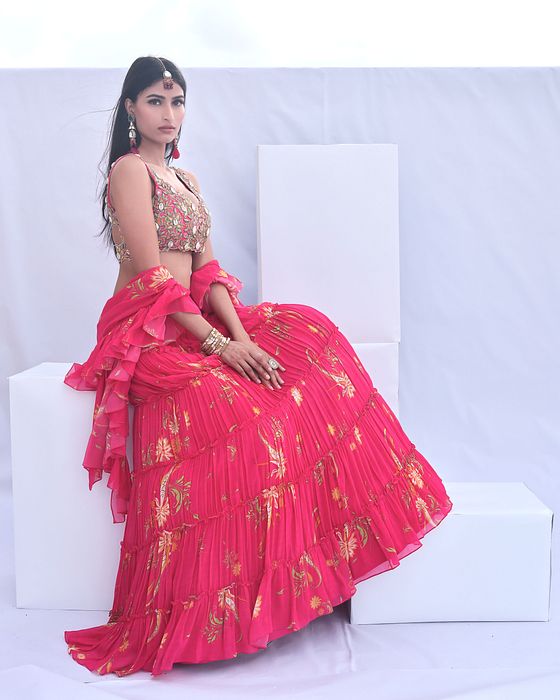 A model showcasing Pink Paisley Print Tiered Lehenga by Foram Patel from Foram Patel's collection
