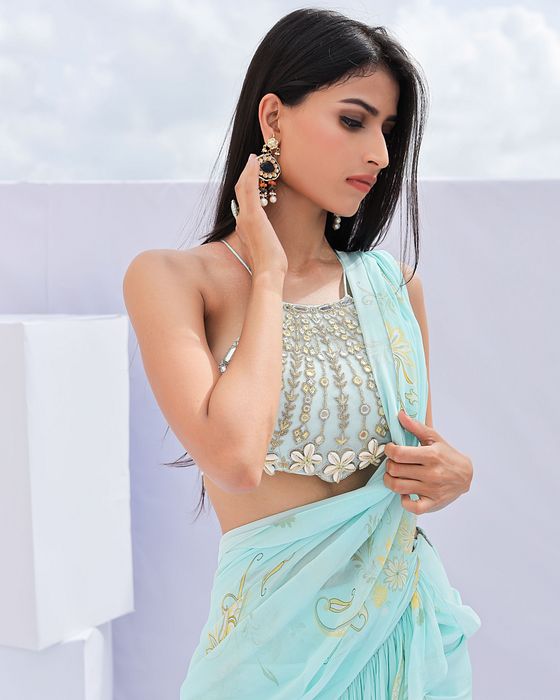 A model showcasing Blue Predraped Ruffle Paisely Print Saree Set by Foram Patel from Foram Patel's collection