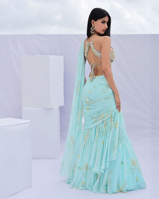 A model showcasing Blue Predraped Ruffle Paisely Print Saree Set by Foram Patel from Foram Patel's collection