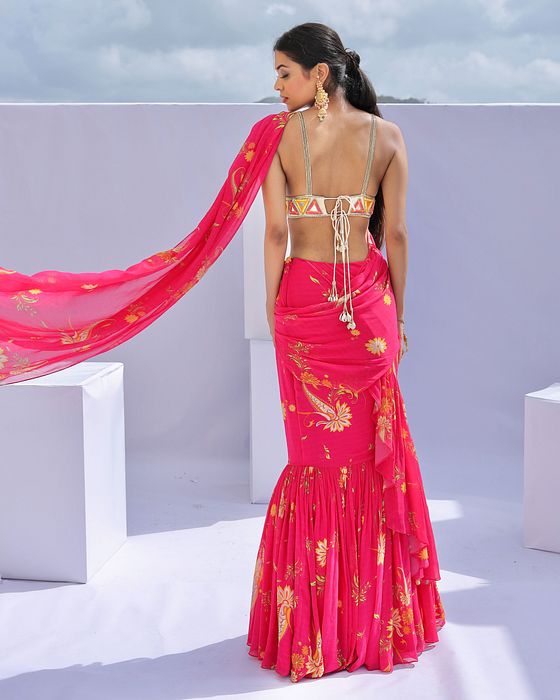 A model showcasing Pink Predraped Ruffle Paisley Print Saree Set by Foram Patel from Foram Patel's collection