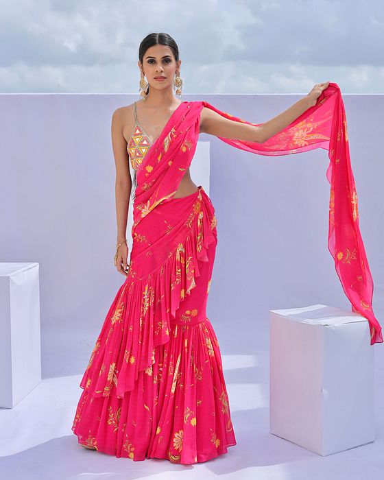 A model showcasing Pink Predraped Ruffle Paisley Print Saree Set by Foram Patel from Foram Patel's collection