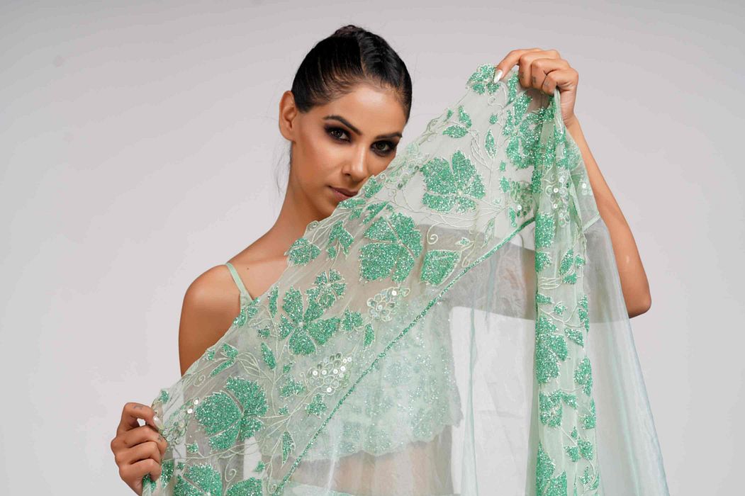 A model showcasing Green Grapewine Cutwork Blouse N Dupatta With Silk Lehenga by Shruti S Label from Shruti S Label's collection