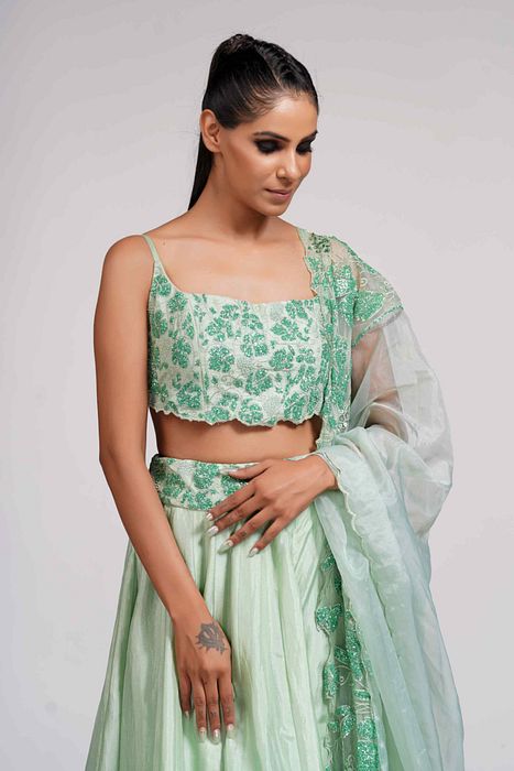 A model showcasing Green Grapewine Cutwork Blouse N Dupatta With Silk Lehenga by Shruti S Label from Shruti S Label's collection