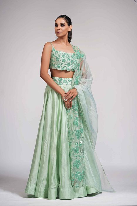 A model showcasing Green Grapewine Cutwork Blouse N Dupatta With Silk Lehenga by Shruti S Label from Shruti S Label's collection