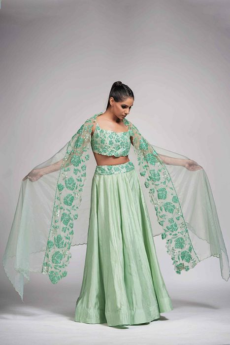 A model showcasing Green Grapewine Cutwork Blouse N Dupatta With Silk Lehenga by Shruti S Label from Shruti S Label's collection