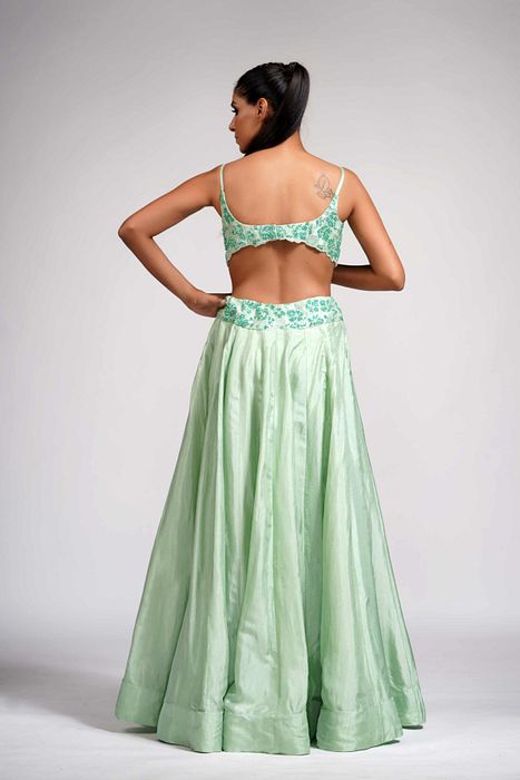 A model showcasing Green Grapewine Cutwork Blouse N Dupatta With Silk Lehenga by Shruti S Label from Shruti S Label's collection