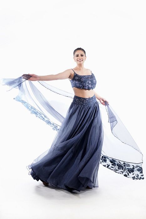 A model showcasing Grey Grapewine Cutwork Blouse N Dupatta With Organza Lehenga by Shruti S Label from Shruti S Label's collection
