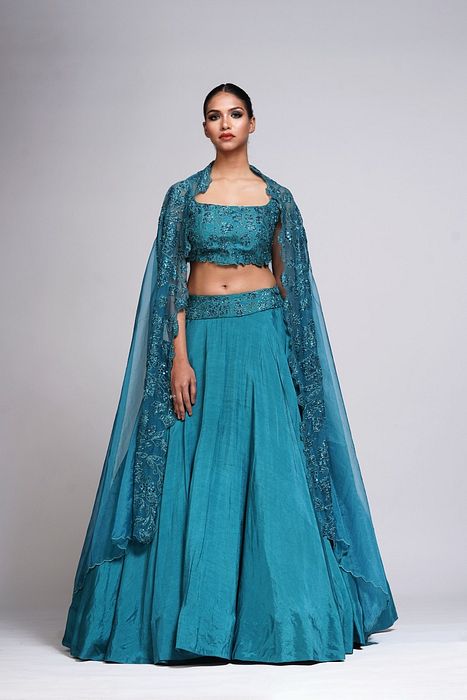 A model showcasing Grapevine Teal Silk Lehenga by Shruti S Label from Shruti S Label's collection