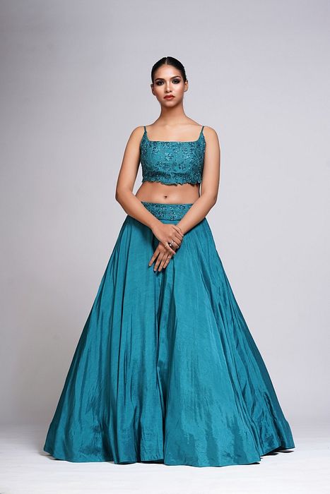 A model showcasing Grapevine Teal Silk Lehenga by Shruti S Label from Shruti S Label's collection