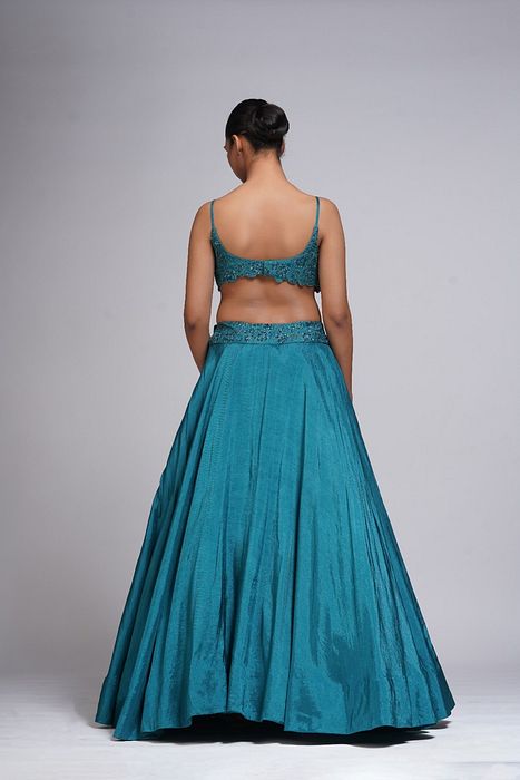 A model showcasing Grapevine Teal Silk Lehenga by Shruti S Label from Shruti S Label's collection
