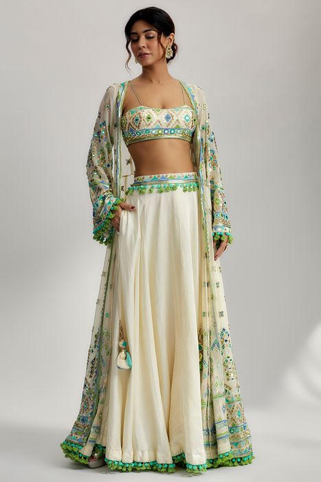 A model showcasing Ridham Jacket Set With Victorian Skirt In Ivory by Gopi Vaid from Gopi Vaid's collection