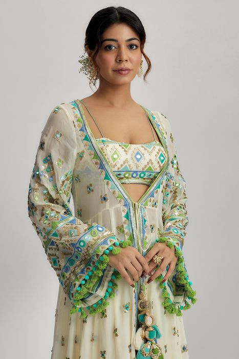A model showcasing Ridham Jacket Set With Victorian Skirt In Ivory by Gopi Vaid from Gopi Vaid's collection