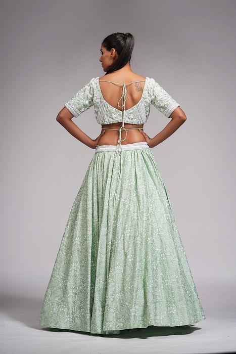 A model showcasing Sage Green Lehenga With Offwhite Hand Paint And Pearl Embroidery by Shruti S Label from Shruti S Label's collection