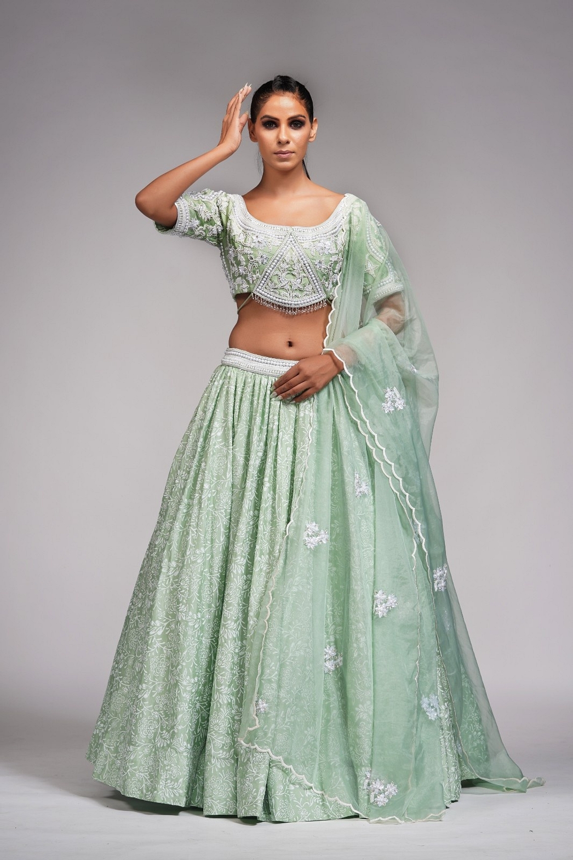 A model showcasing Sage Green Lehenga With Offwhite Hand Paint And Pearl Embroidery Feature image by Shruti S Label from Shruti S Label's collection