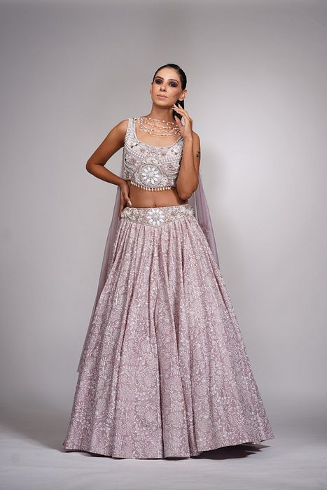 A model showcasing Lilac Lehenga With Offwhite Hand Paint Pearl Embroidery by Shruti S Label from Shruti S Label's collection