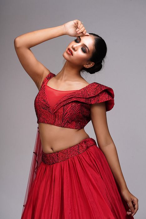 A model showcasing Red Lehenga Gown For Cocktails by Shruti S Label from Shruti S Label's collection