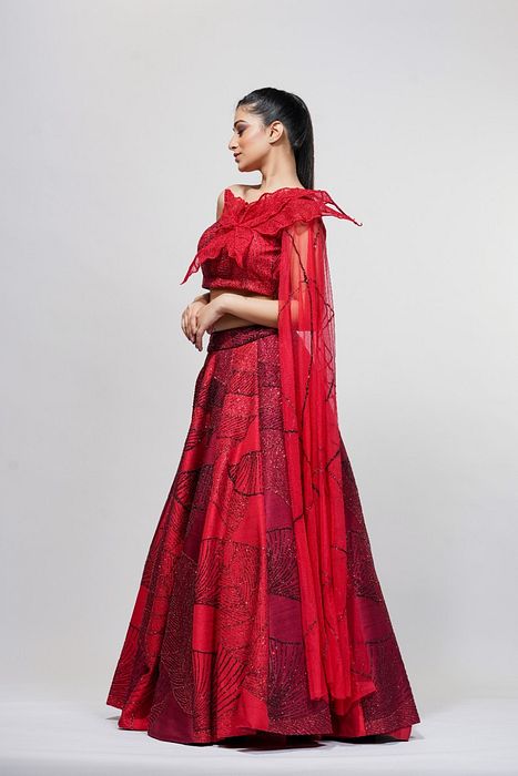 A model showcasing Leaves Red Lehenga Gown by Shruti S Label from Shruti S Label's collection