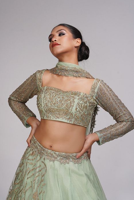 A model showcasing Pastel Green Zari Lehenga by Shruti S Label from Shruti S Label's collection