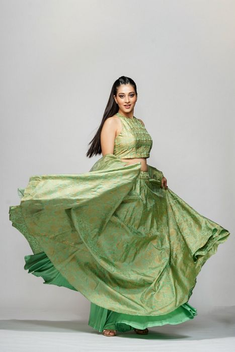 A model showcasing Metallic Hand Block Print Lehenga Sage Green by Shruti S Label from Shruti S Label's collection