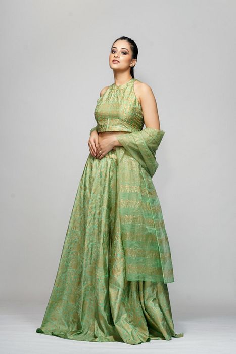 A model showcasing Metallic Hand Block Print Lehenga Sage Green by Shruti S Label from Shruti S Label's collection