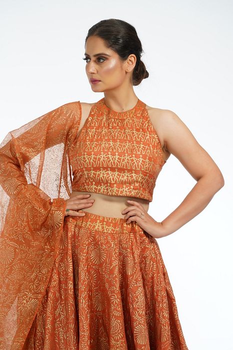 A model showcasing Burnt Orange Metallic Hand Painted Lehenga by Shruti S Label from Shruti S Label's collection