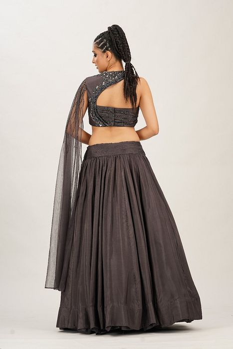 A model showcasing Lead Grey Cross Body Bustier Lehenga by Shruti S Label from Shruti S Label's collection
