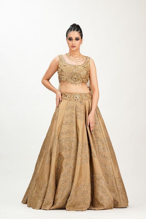 A model showcasing Gold Midal Touch Lehenga by Shruti S Label from Shruti S Label's collection