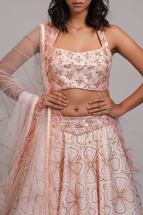 A model showcasing Peach Heavy Embroidered Lehenga With Feathers On Dupatta by Shruti S Label from Shruti S Label's collection