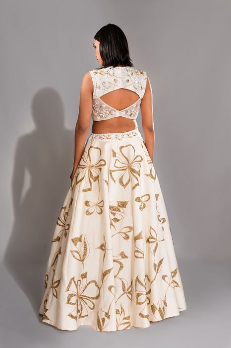 A model showcasing Offwhite And Gold Lehenga With Sequins Work by Shruti S Label from Shruti S Label's collection