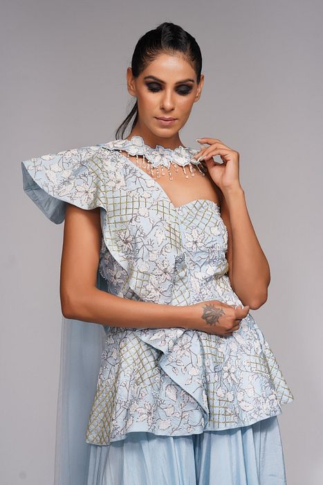 A model showcasing White Embroidery Peplum Sharara by Shruti S Label from Shruti S Label's collection