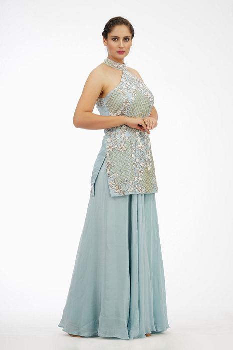 A model showcasing Ice Blue Halter Neck Sharara Set by Shruti S Label from Shruti S Label's collection