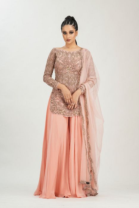 A model showcasing Bateau Neck Peach Gold Sharara by Shruti S Label from Shruti S Label's collection