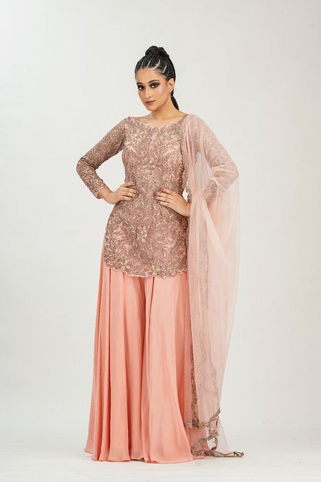 A model showcasing Bateau Neck Peach Gold Sharara by Shruti S Label from Shruti S Label's collection