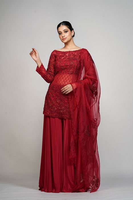 A model showcasing Red Cocktail Sharara by Shruti S Label from Shruti S Label's collection