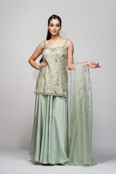 A model showcasing Silver Gold Sharara Set by Shruti S Label from Shruti S Label's collection