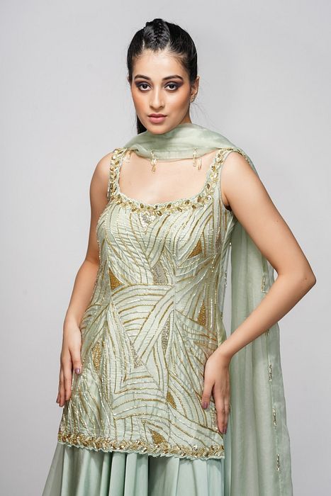 A model showcasing Silver Gold Sharara Set by Shruti S Label from Shruti S Label's collection