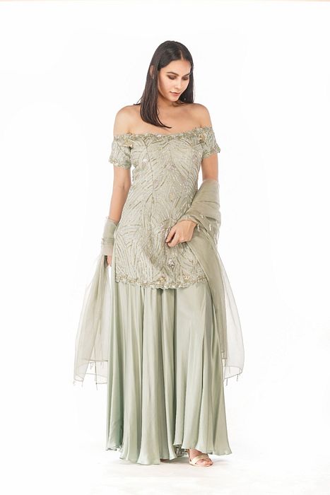 A model showcasing Sea Weed Off Soulder Sharara Set by Shruti S Label from Shruti S Label's collection A model showcasing Sea Weed Off Soulder Sharara Set by Shruti S Label from Shruti S Label's collection